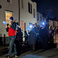 The band-led children's procession arriving at the village centre